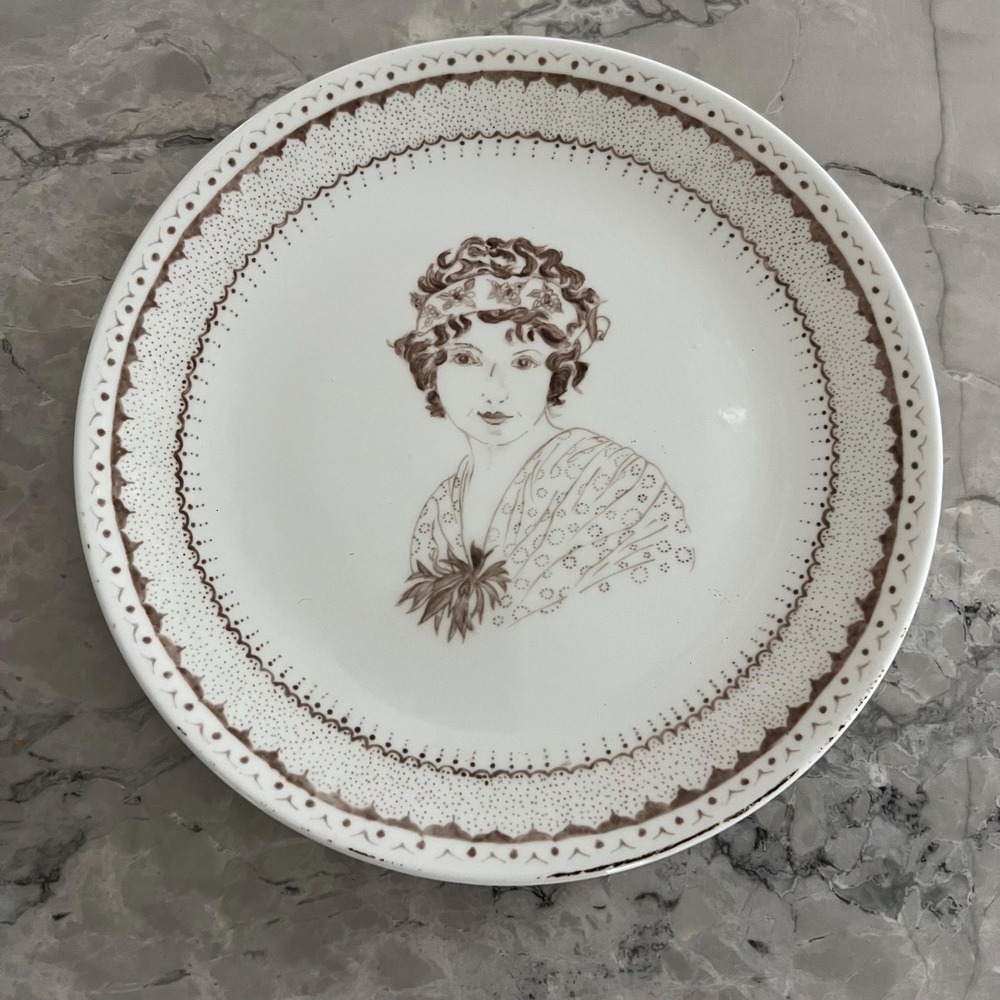 Handpainted 9.5" plate featuring woman signed "S. Bailey"‎